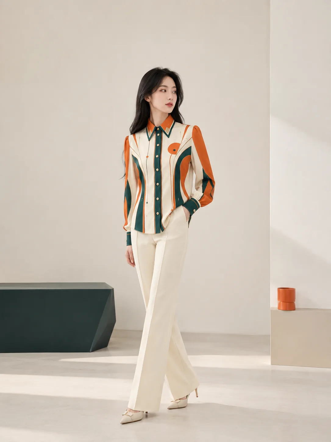 Model wearing the orange and green printed shirt in a clean studio